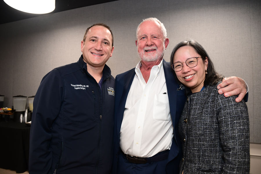 Richard Andrassy, MD, poses with two colleagues during the celebration honoring his retirement as chair.