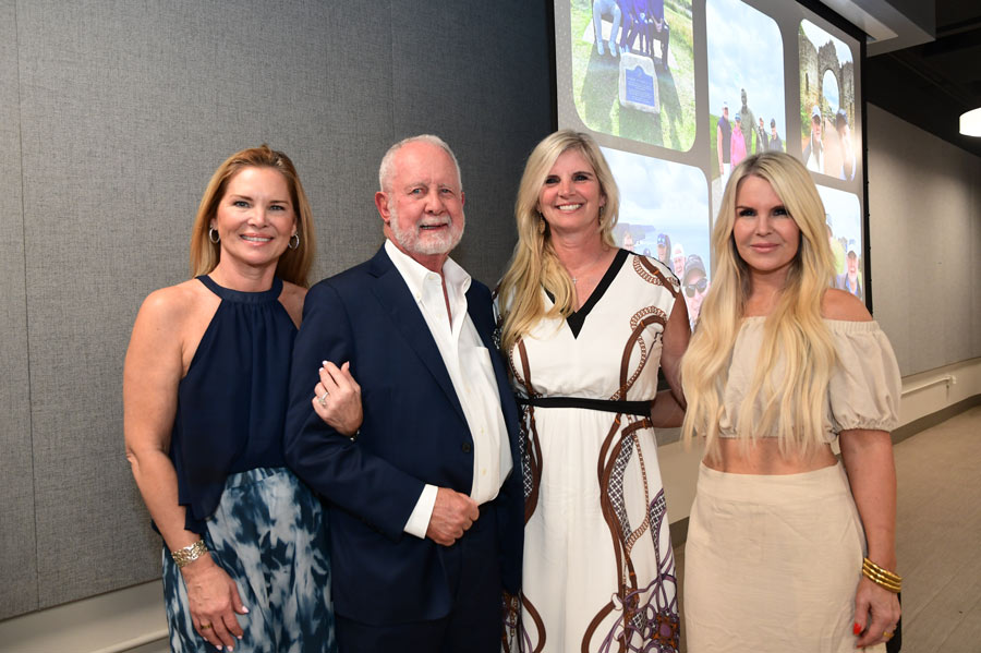 Richard Andrassy, MD, poses with his daughters during a celebration honoring his retirement after 32 years as chair.