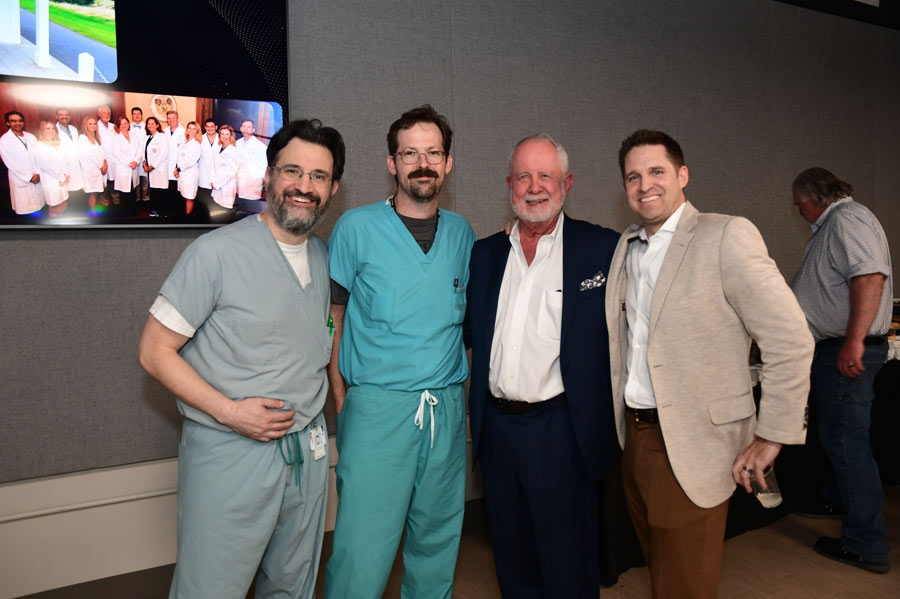Richard Andrassy, MD, poses with three colleagues during a celebration honoring his retirement as chair.