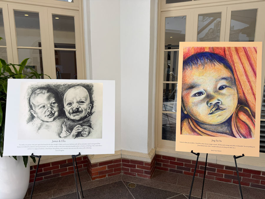 Portraits of three infants born with cleft differences displayed on easels during the 100 Cleft Portraits Tour.
