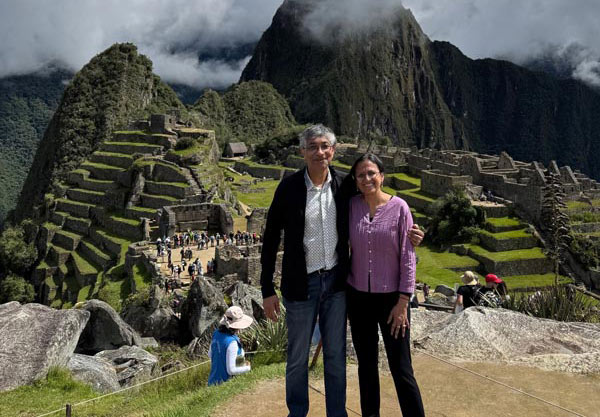 Vasanthi Jayaraman, PhD, and her husband, Ramanan Krishnamoorti, PhD, pose together overlooking the ancient stone terraces and mountainous landscape of Machu Picchu in Peru.
