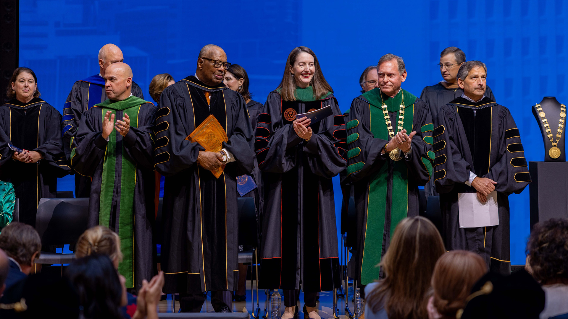 Melina R. Kibbe, MD, stands with UTHealth Houston leaders and faculty members in academic regalia during her presidential investiture ceremony.