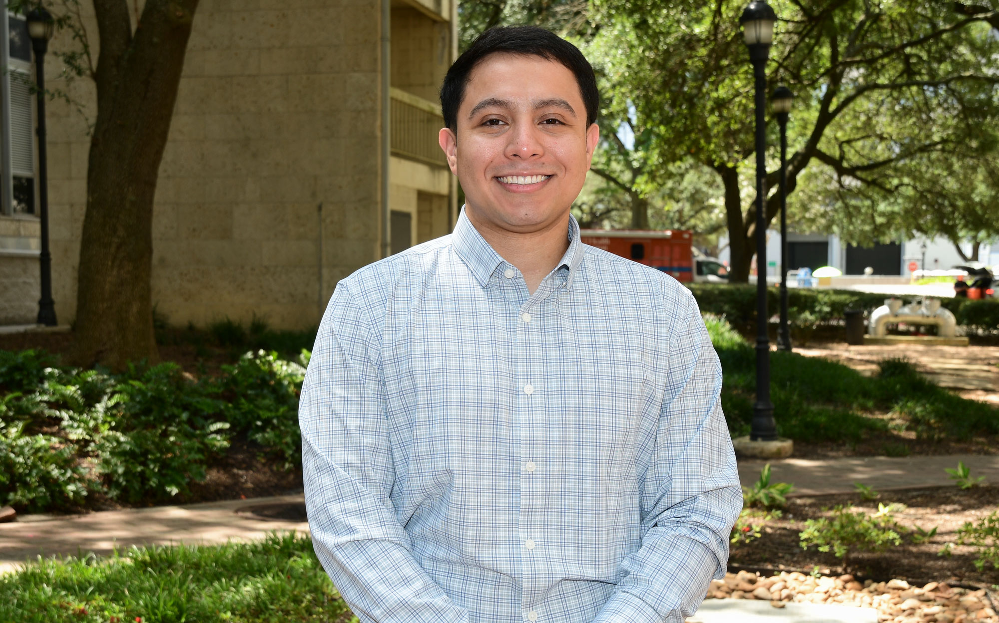 Bryan Alfaro poses for a photo in Webber Plaza at McGovern Medical School