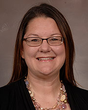 Dr. Sandray McKay poses for a professional headshot with a black shirt